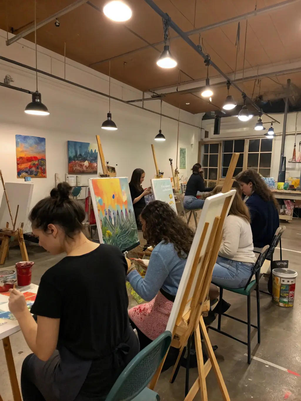A vibrant photograph capturing a group of students actively participating in an art workshop at FRAC Pays de la Loire, showcasing hands-on learning and creative exploration.